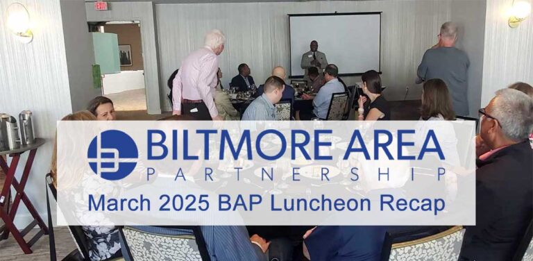 Attendees seated around a table during the BAP March Luncheon as a speaker presents at the front of the room