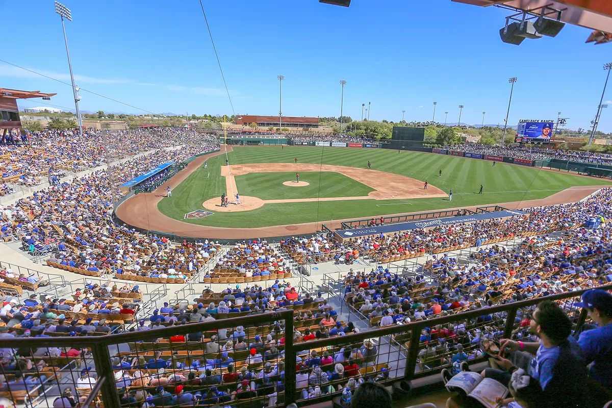 Packed Spring Training baseball stadium in Phoenix area during a Cactus League game on a sunny day.