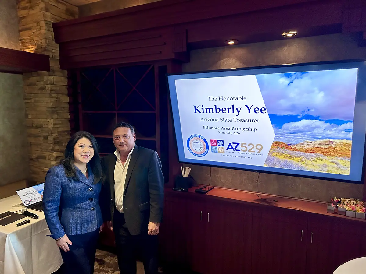 Arizona State Treasurer Kimberly Yee with Phil Tibi at the BAP luncheon Arizona State Treasurer Kimberly Yee with Phil Tibi at the March 24, 2026 BAP luncheon in front of the event presentation screen